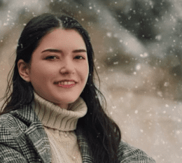 Melissa smiling with snow falling in background