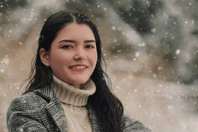 Melissa smiling with snow falling in background