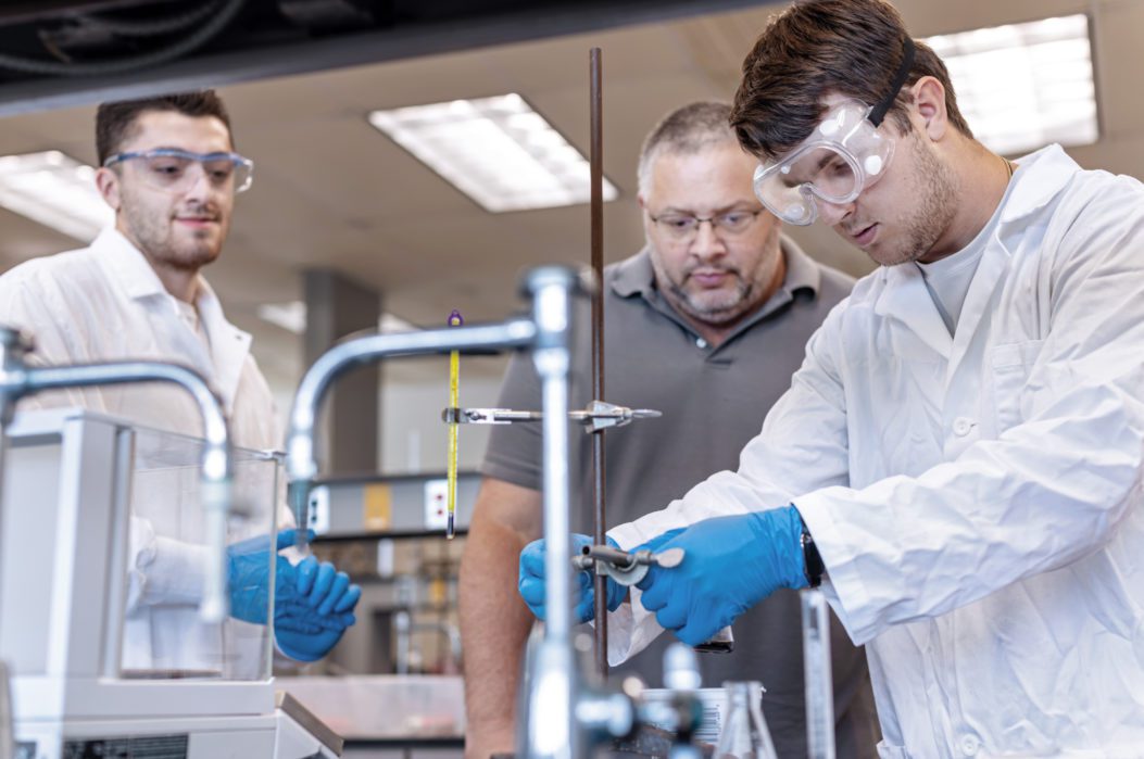 Two students with professor in Biotechnology lab