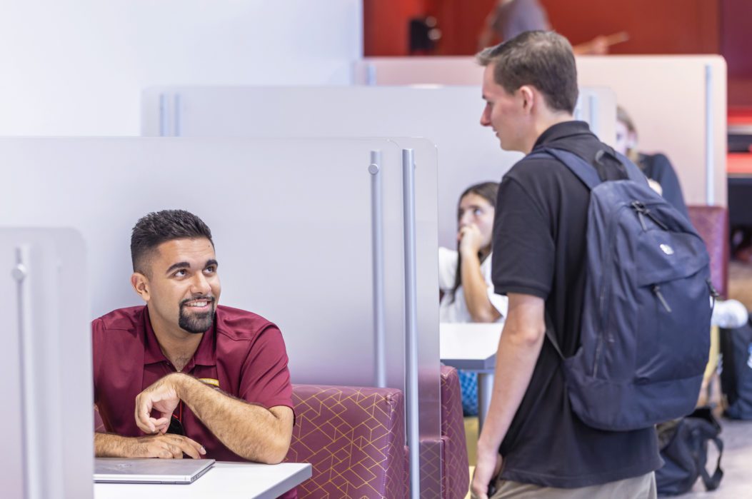 Two male students in the Romano student alumni center.