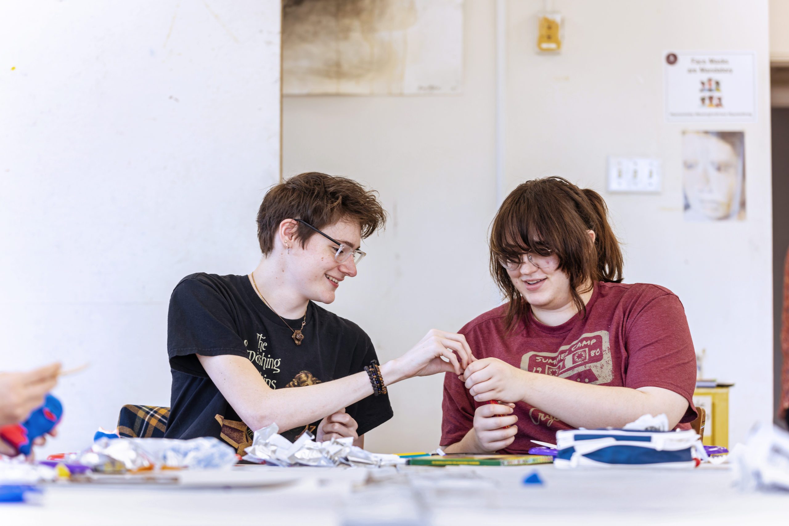 Male and female student working on a clay model in an Art Therapy class