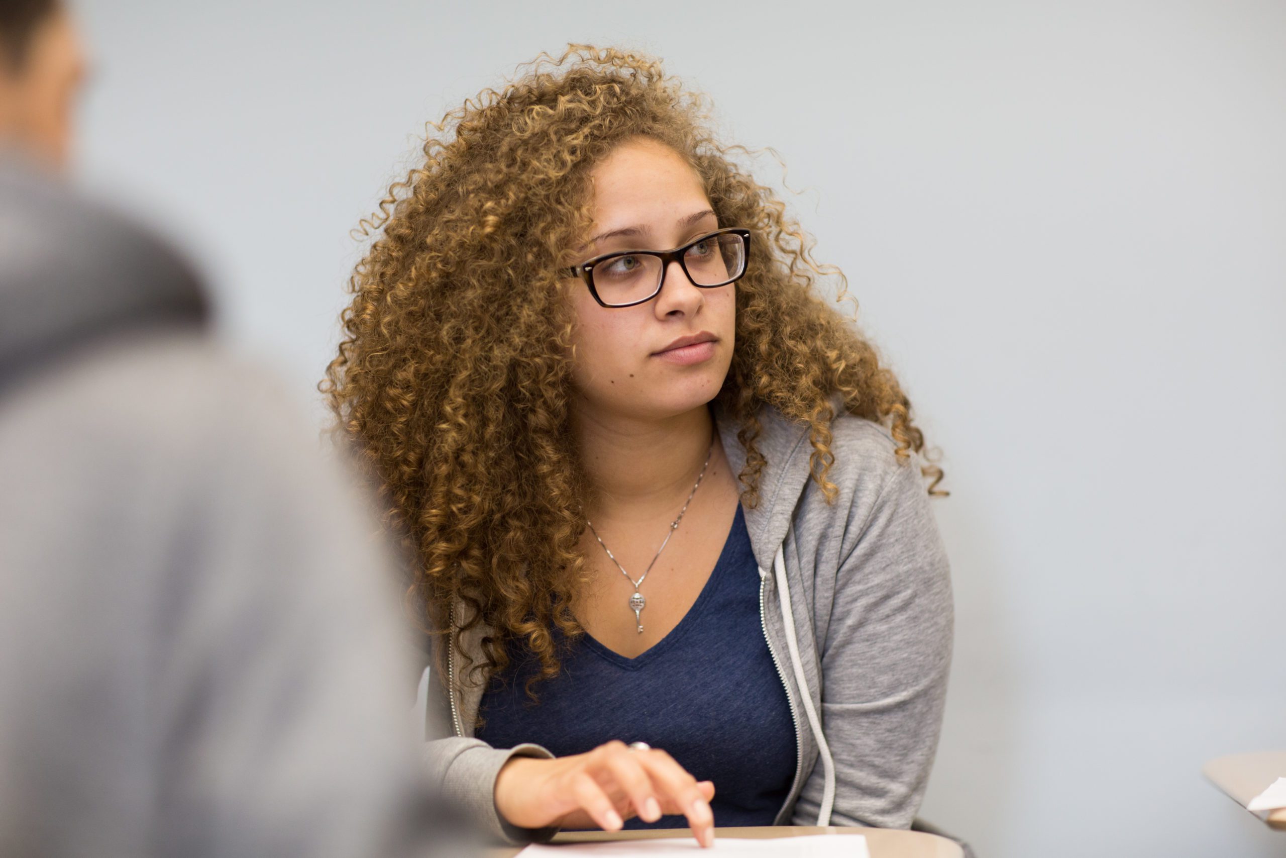 A female student sitting at a desk.