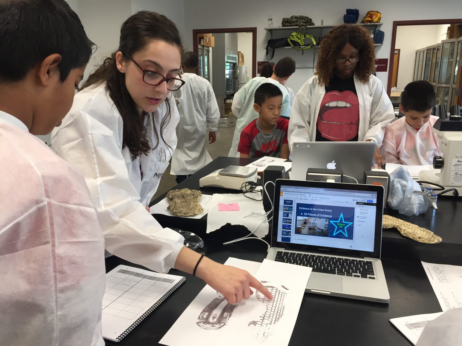 Students and children working in a lab.