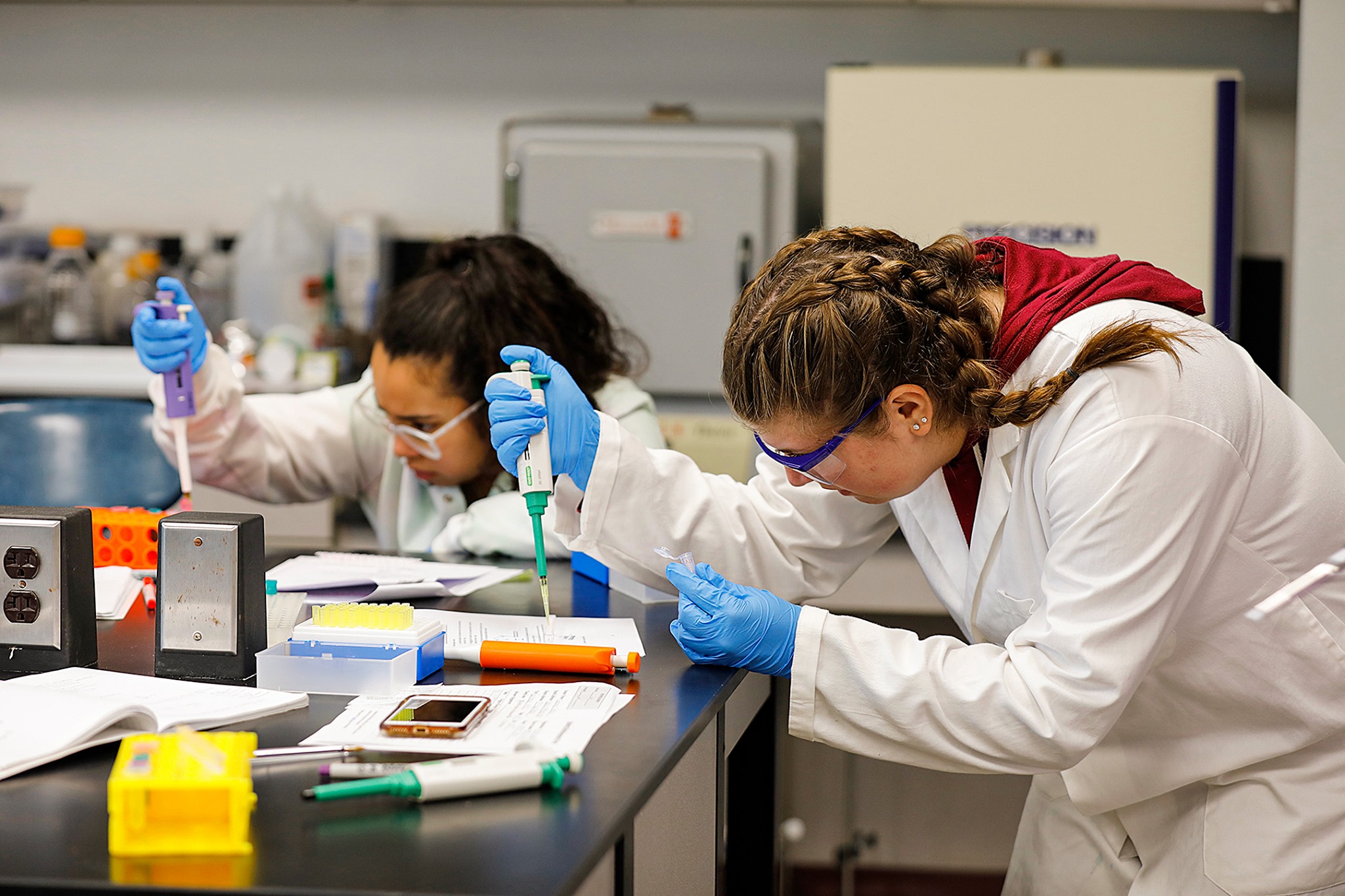 Two female students working in the chemistry lab.