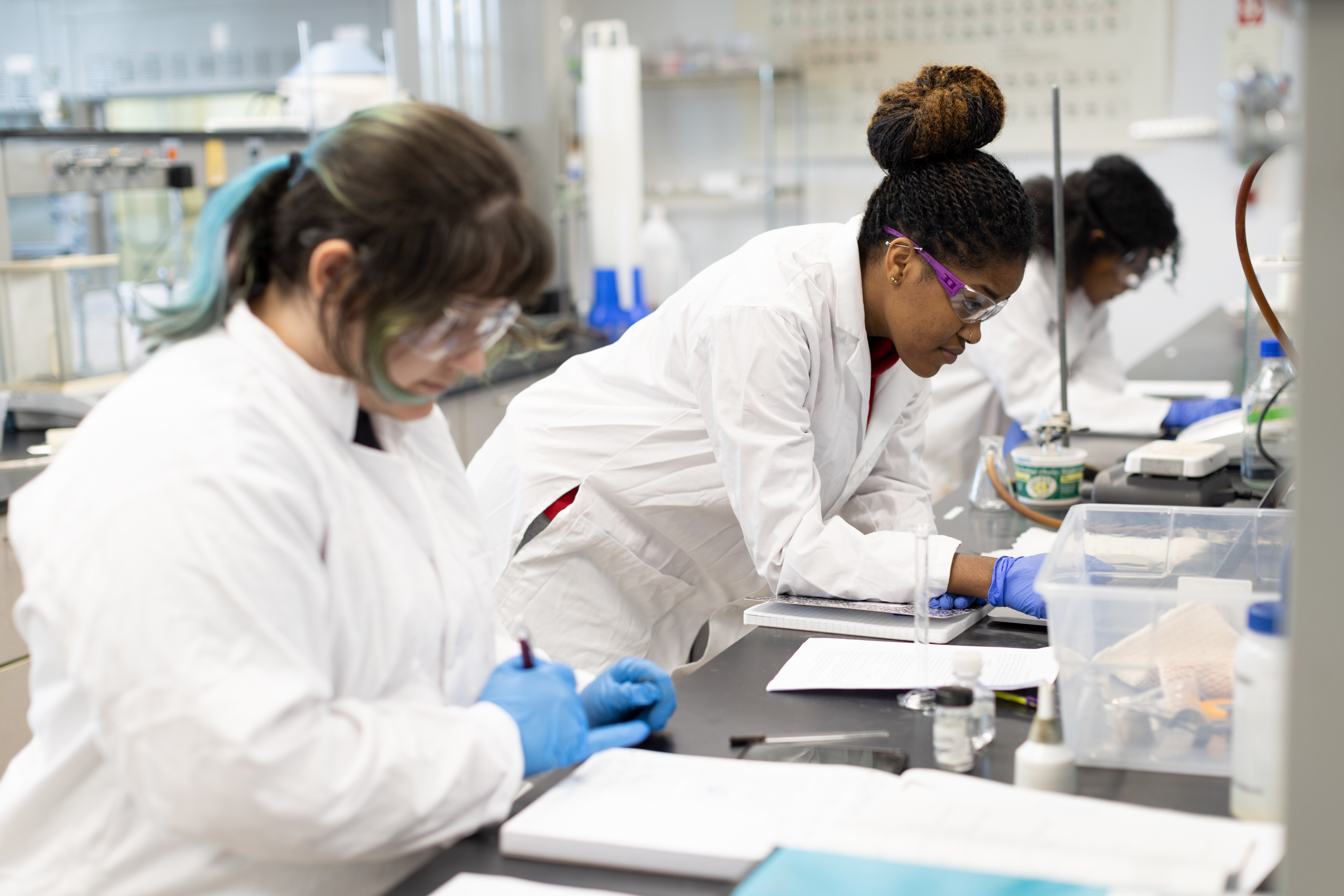 Female students in the lab working on an experiment.