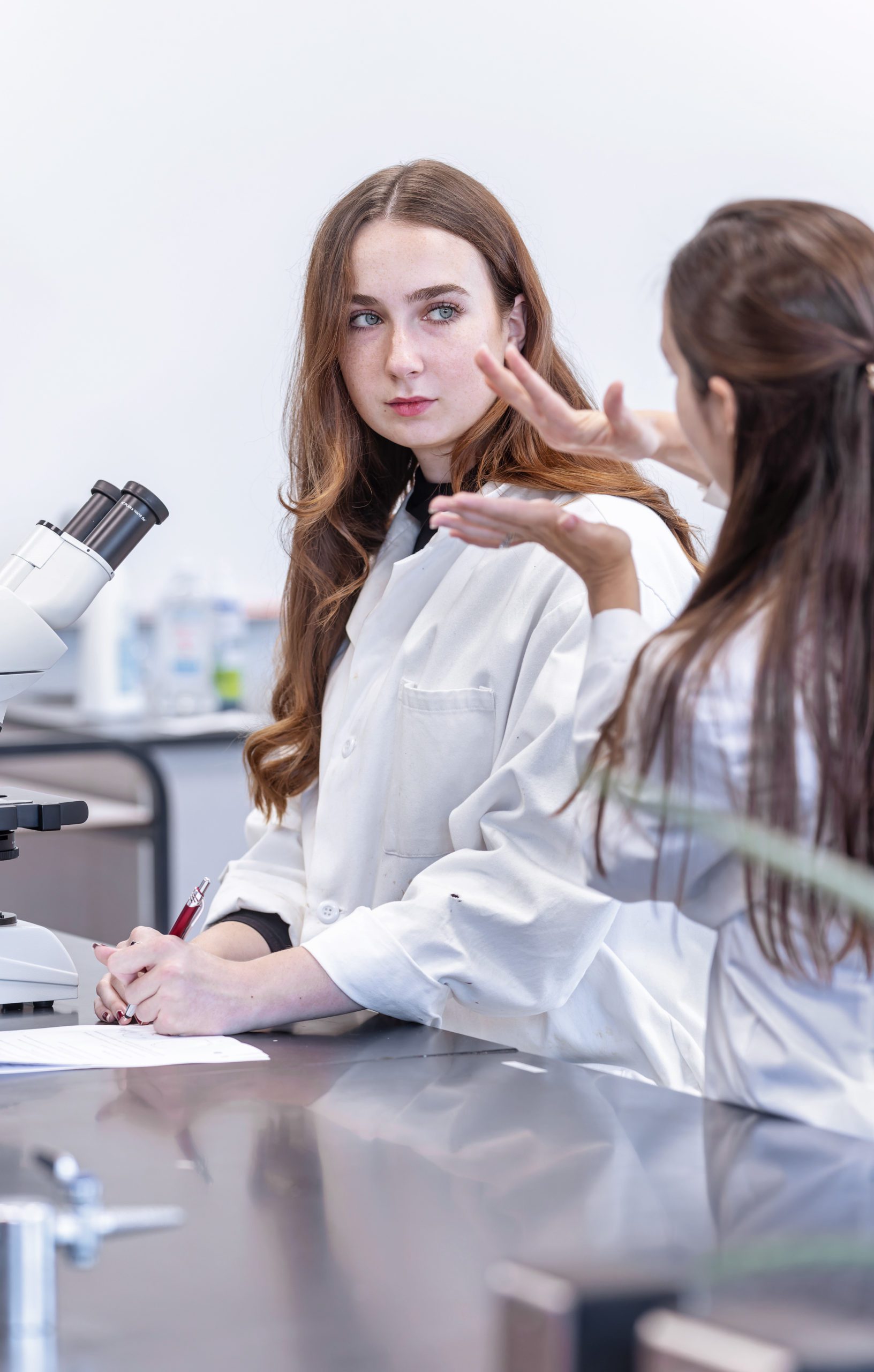 A female student and Dr. Wentzell talking in the Biology lab.