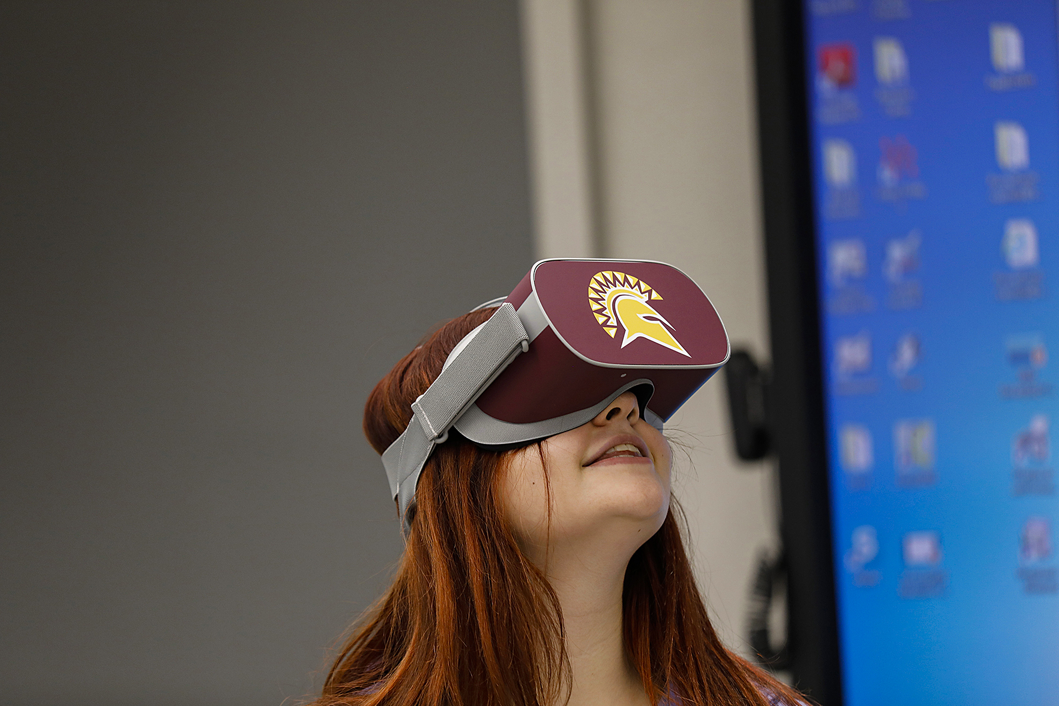 A female student in the VR room with a virtual reality headset on.