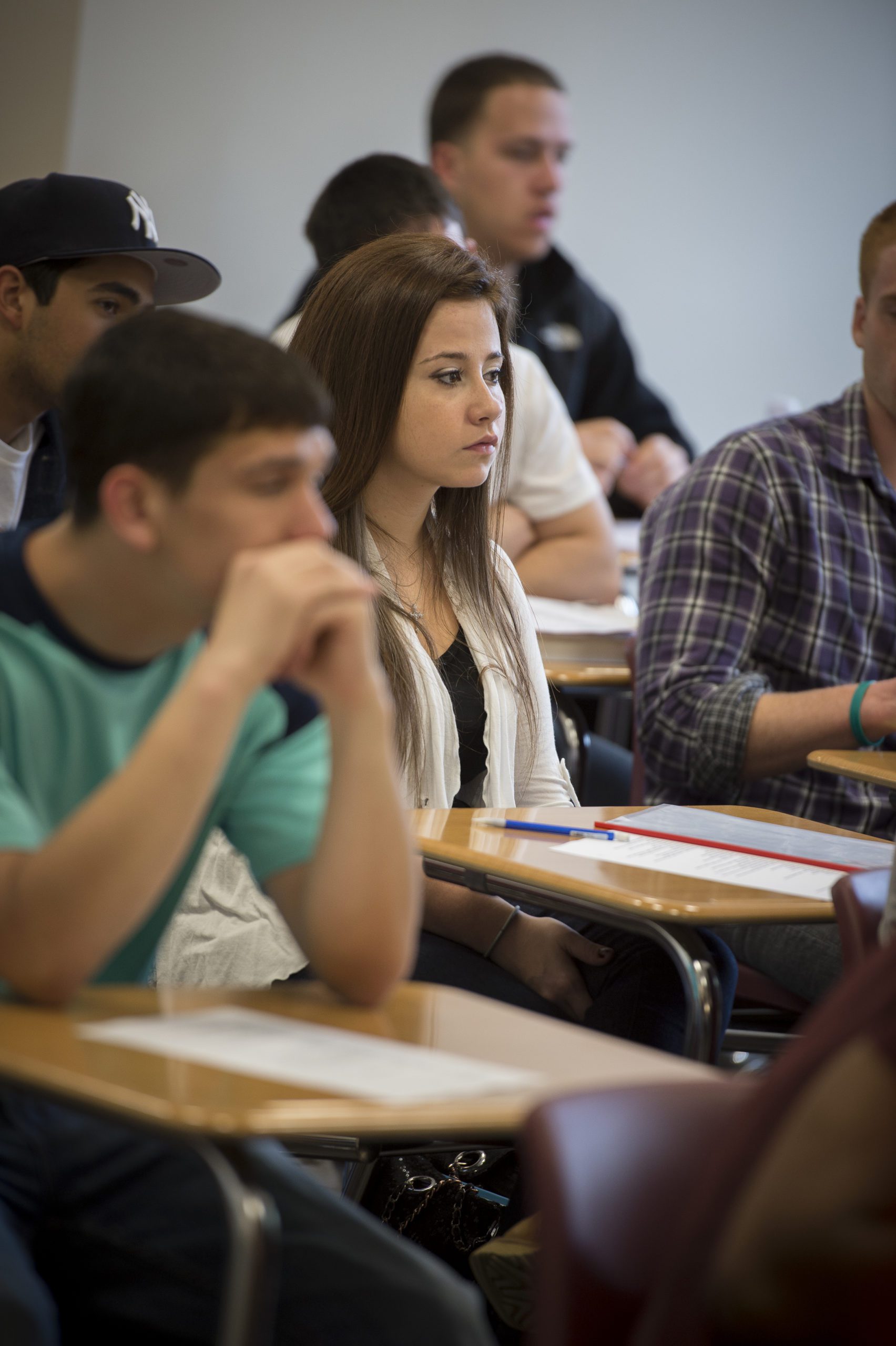 students sitting at desks in a classroom.