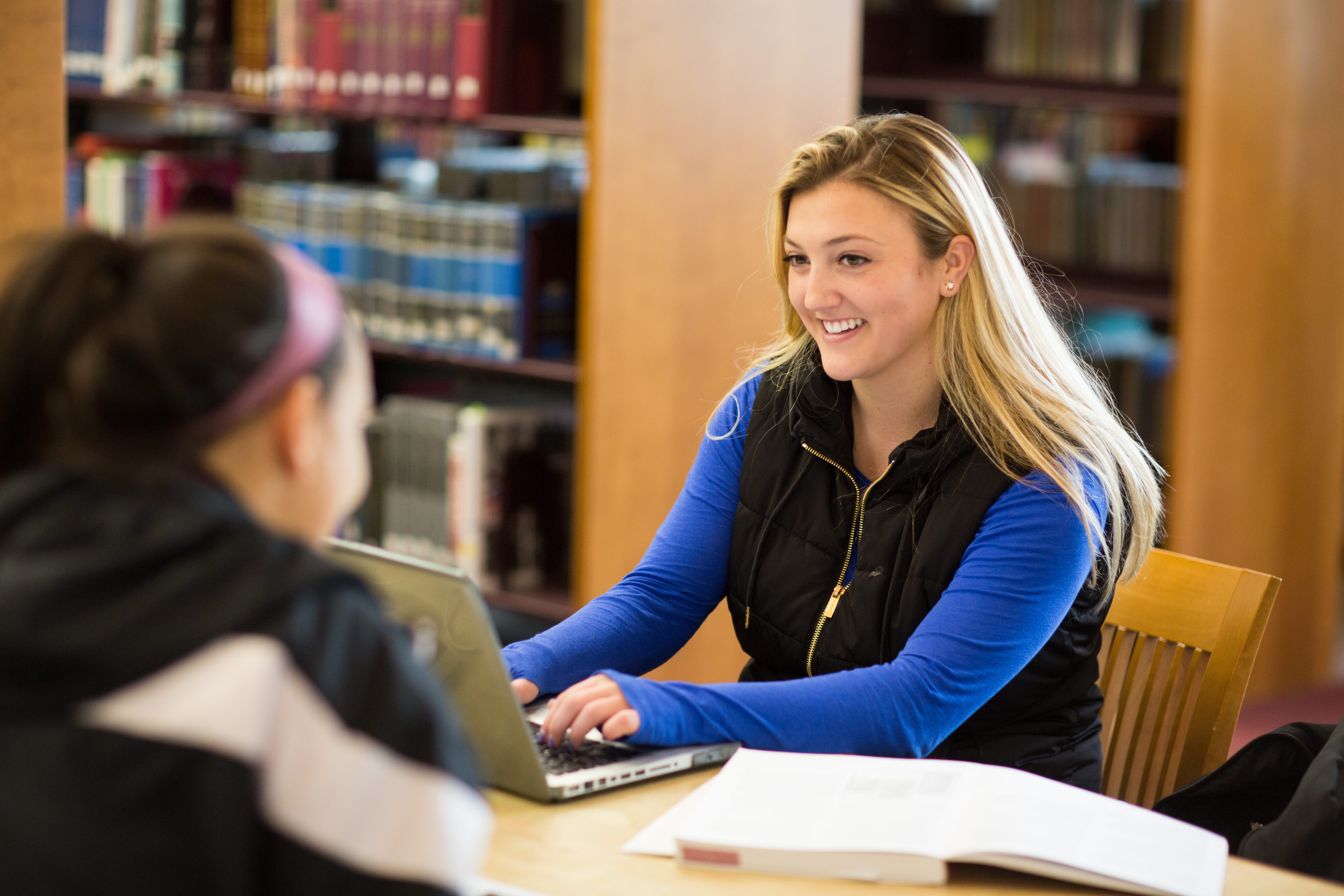 students sitting at desks in the library.