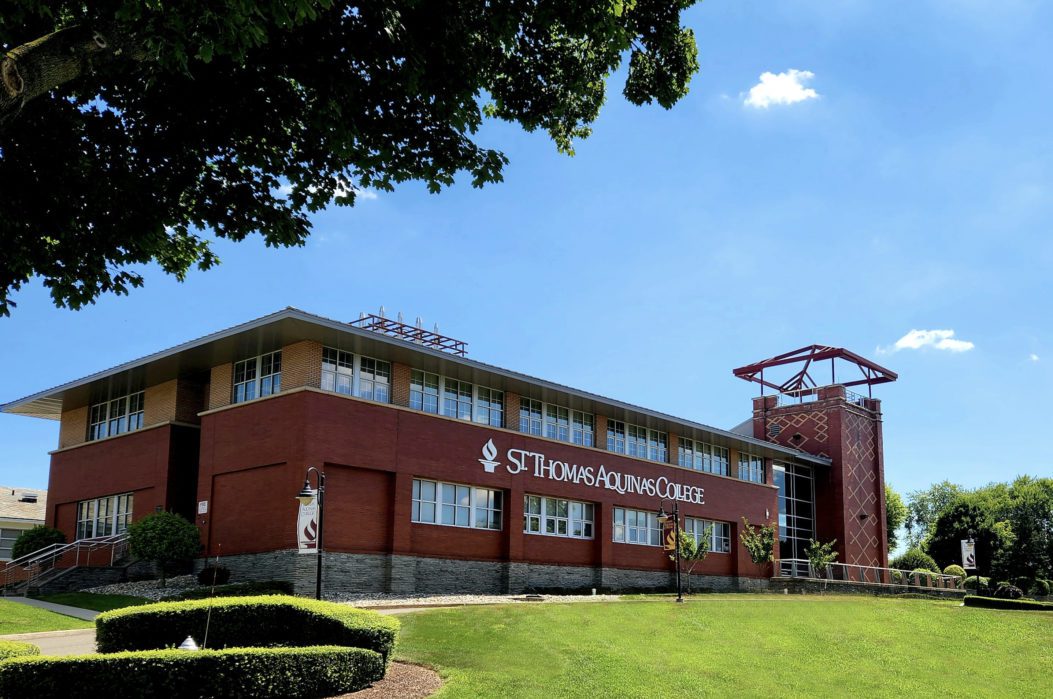 Exterior of Costello Hall building with St. Thomas Aquinas College logo