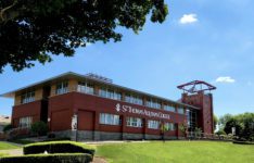 Exterior of Costello Hall building with St. Thomas Aquinas College logo