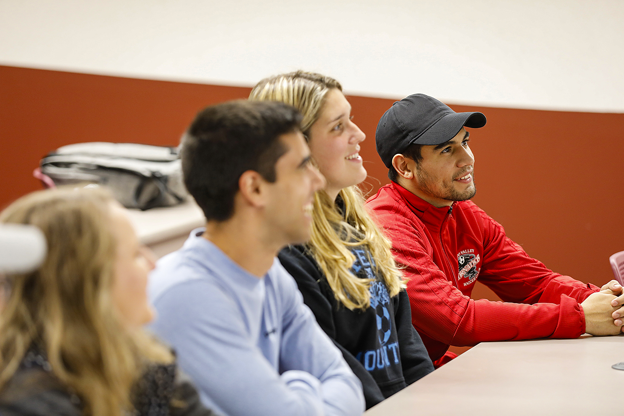 students sitting at desks in the classroom.