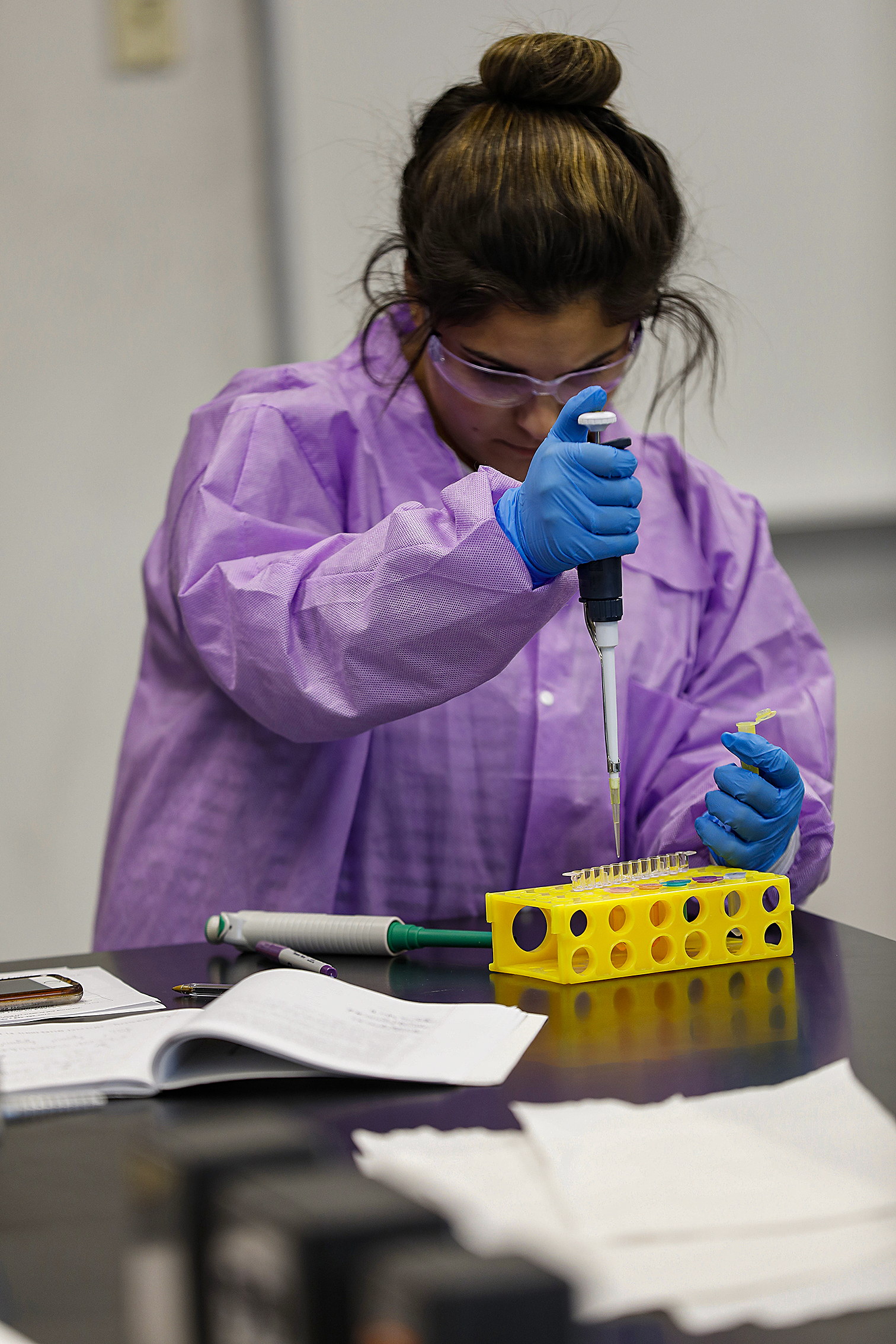 A female student working on an experiment in the chemistry lab.