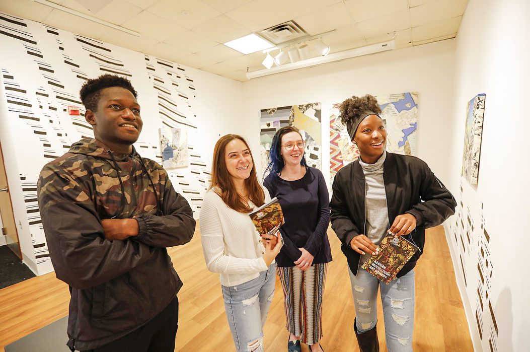 Four students in an art gallery.