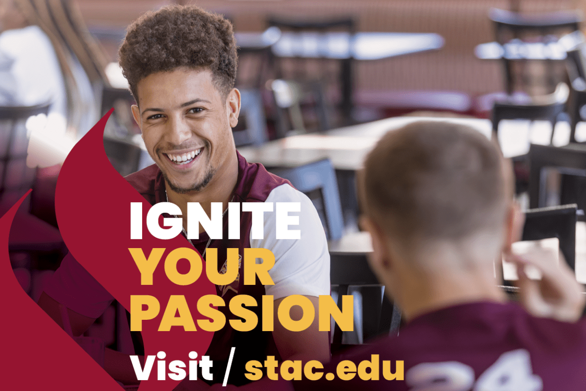 Ignite Your Passion visit stac.edu text and college logo in white with image in background of maroon torch and student in cafeteria smiling