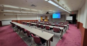 cLASSROOM SEATING WITH PROJECTOR AND WHITE BOARD IN BACKGROUND