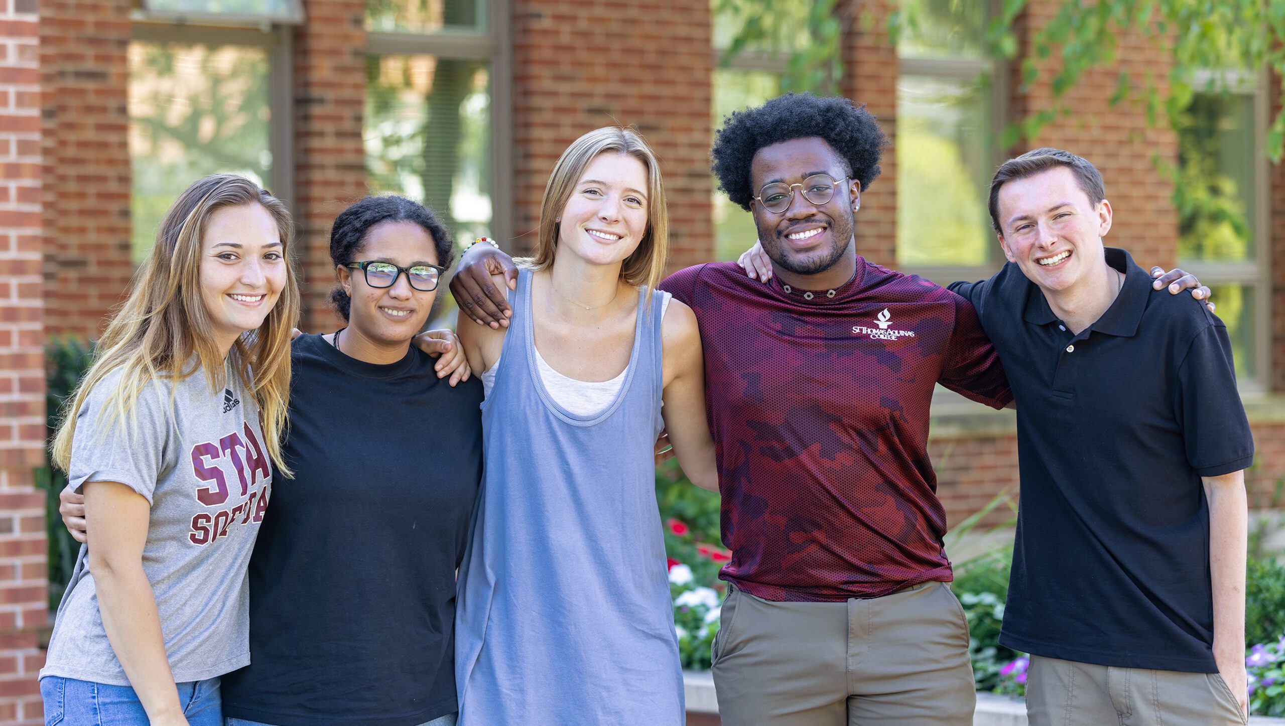 5 students smiling in front of borelli hall
