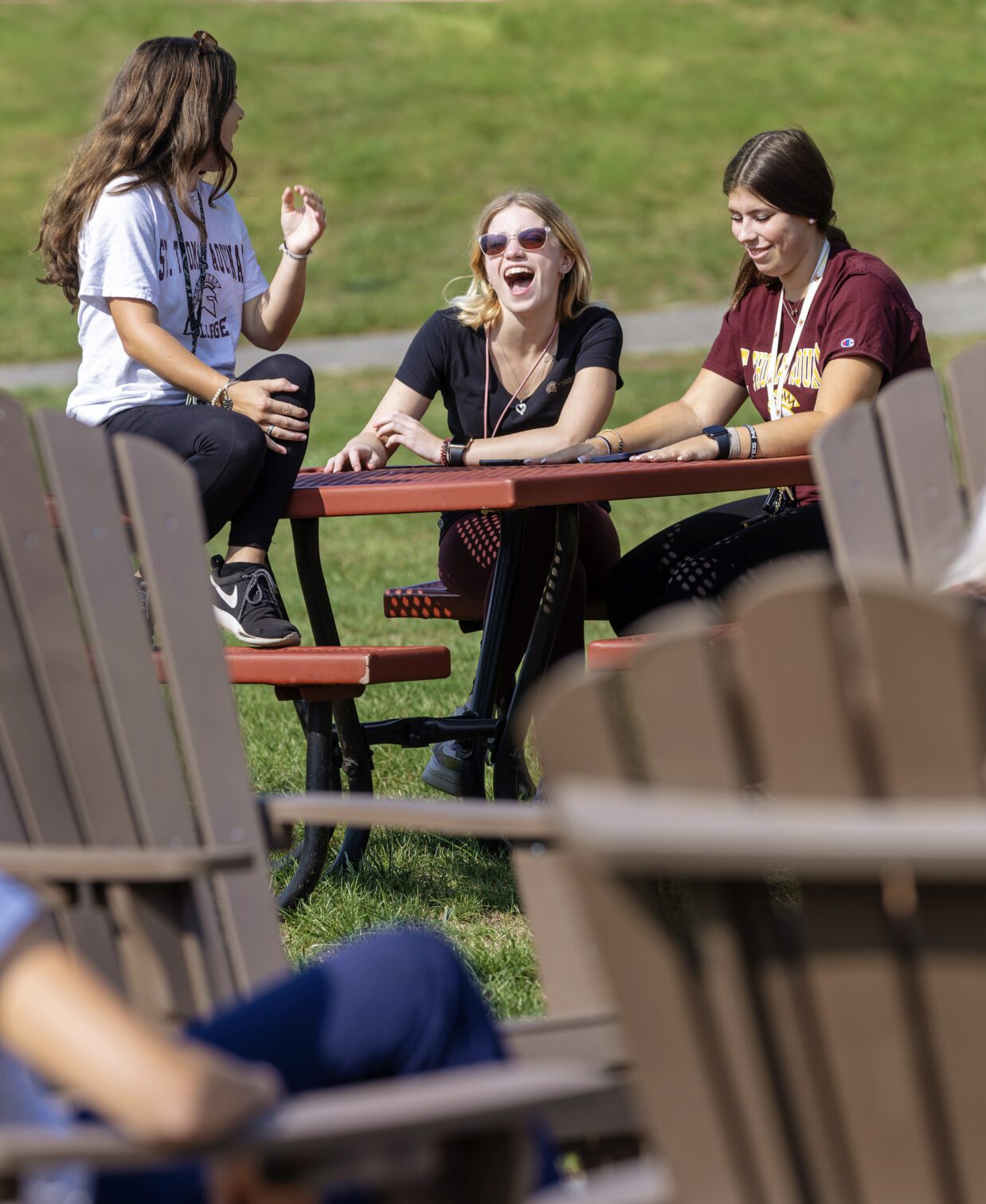 Three female students laughing and enjoying the outdoors