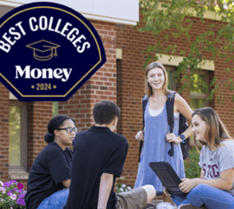 4 students seated outside of Borelli Hall chatting and Money Best Colleges navy blue badge on top left corner