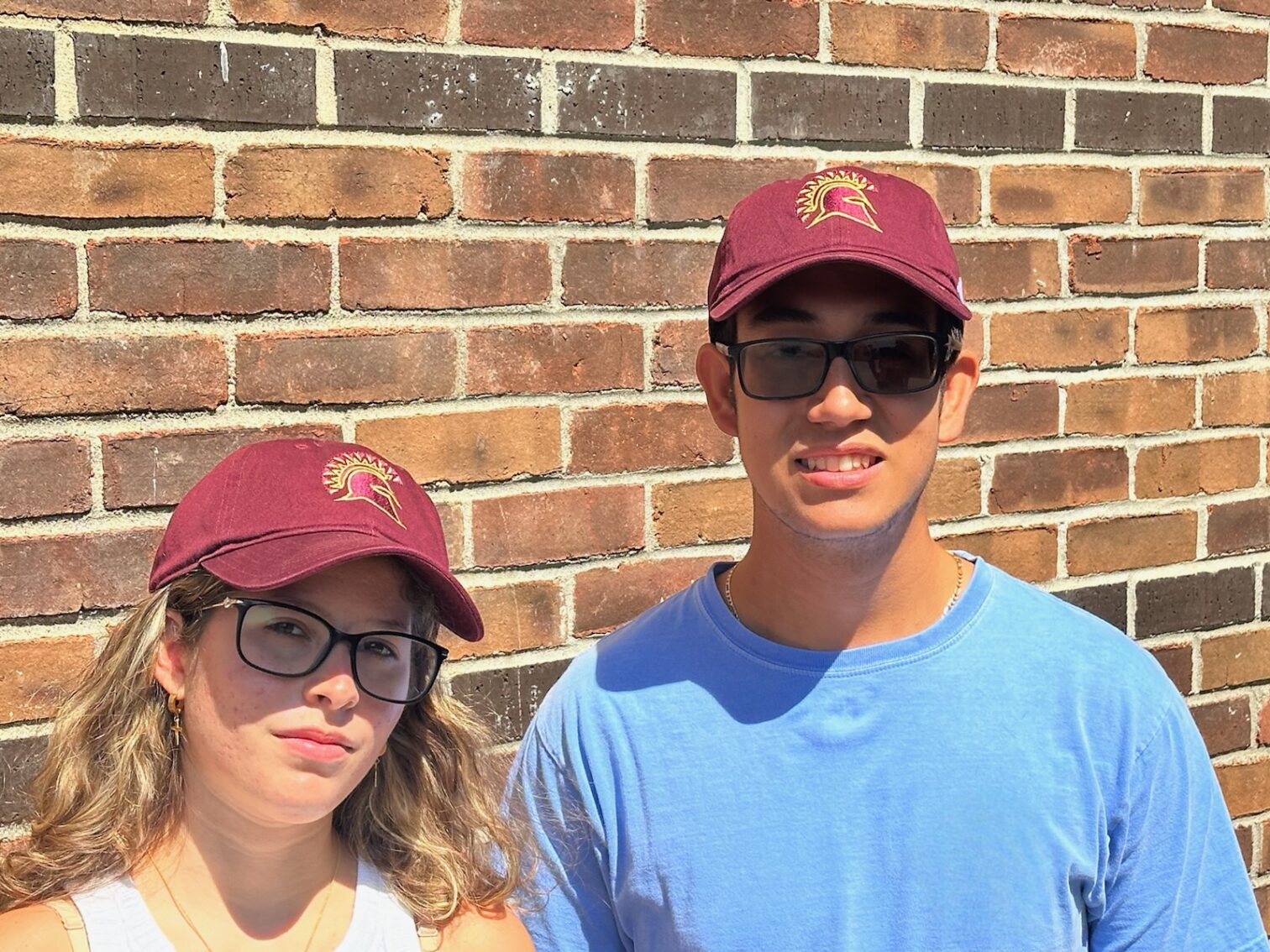 Two students wearing STAC Hats