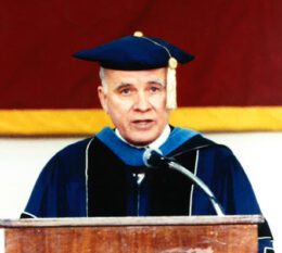 Dr. McNelis in presidential regalia speaking