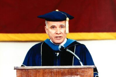 Dr. McNelis in presidential regalia speaking