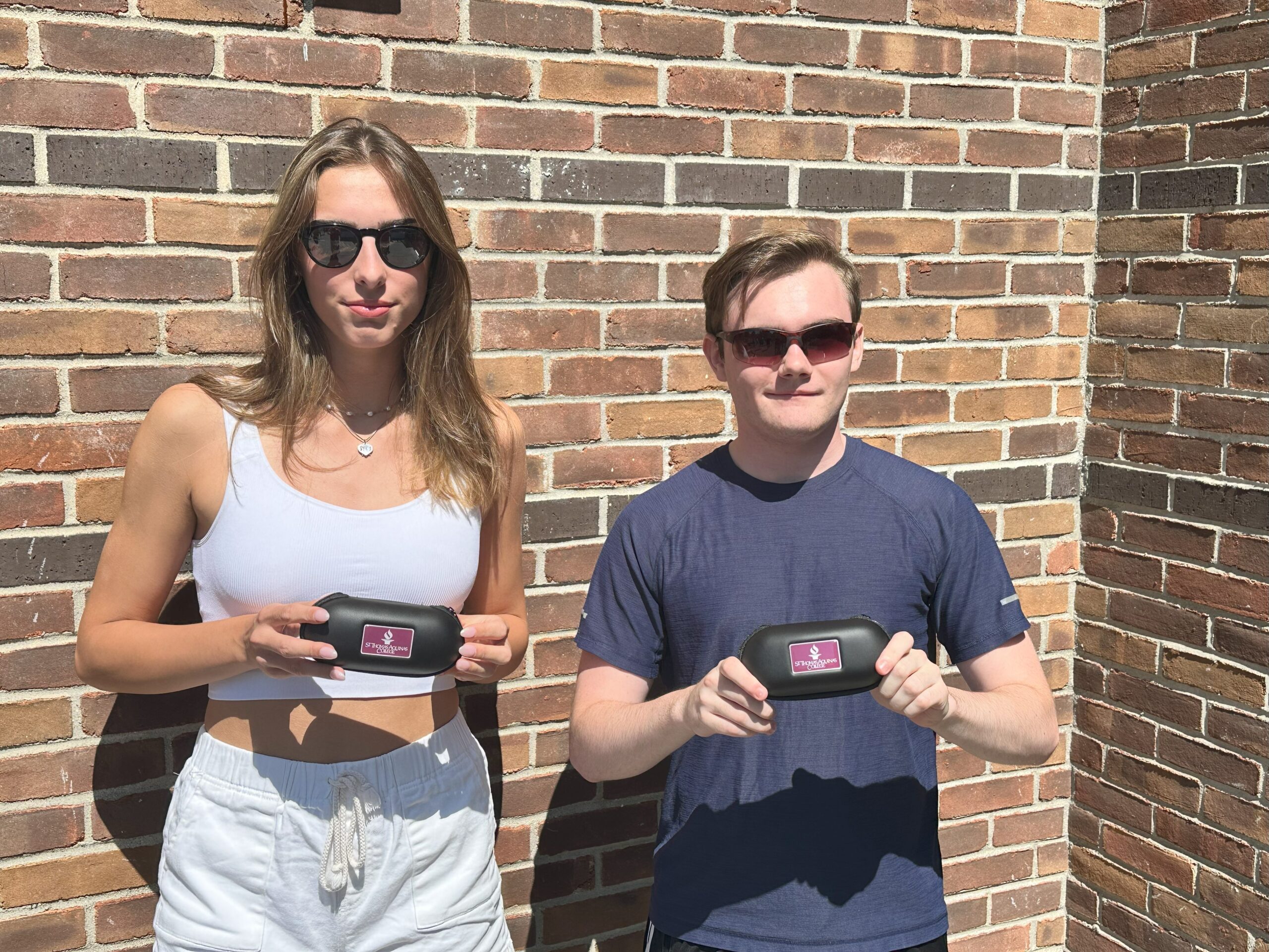 Two students wearing sunglasses with STAC Branded Cases