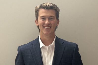 Will smiling wearing navy suit jacket